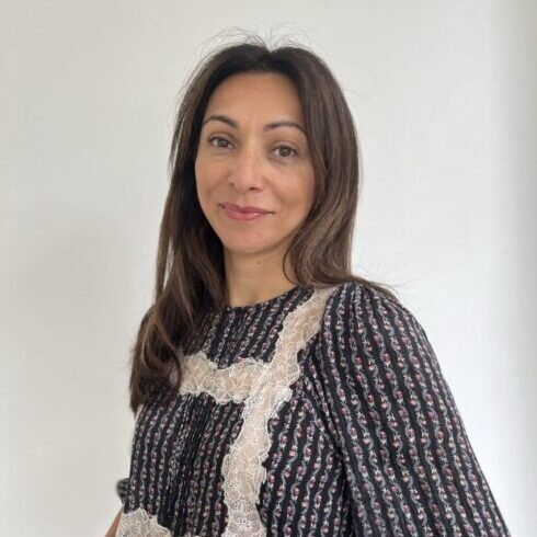 a coloured woman smiling at the camera
